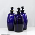 Georgian set of three Bristol blue gilded barrel-shaped decanters
