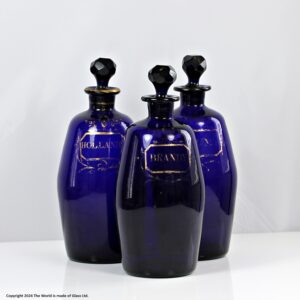 Georgian set of three Bristol blue gilded barrel-shaped decanters