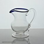 Georgian plain bowl cream jug with blue glass rim, folded foot