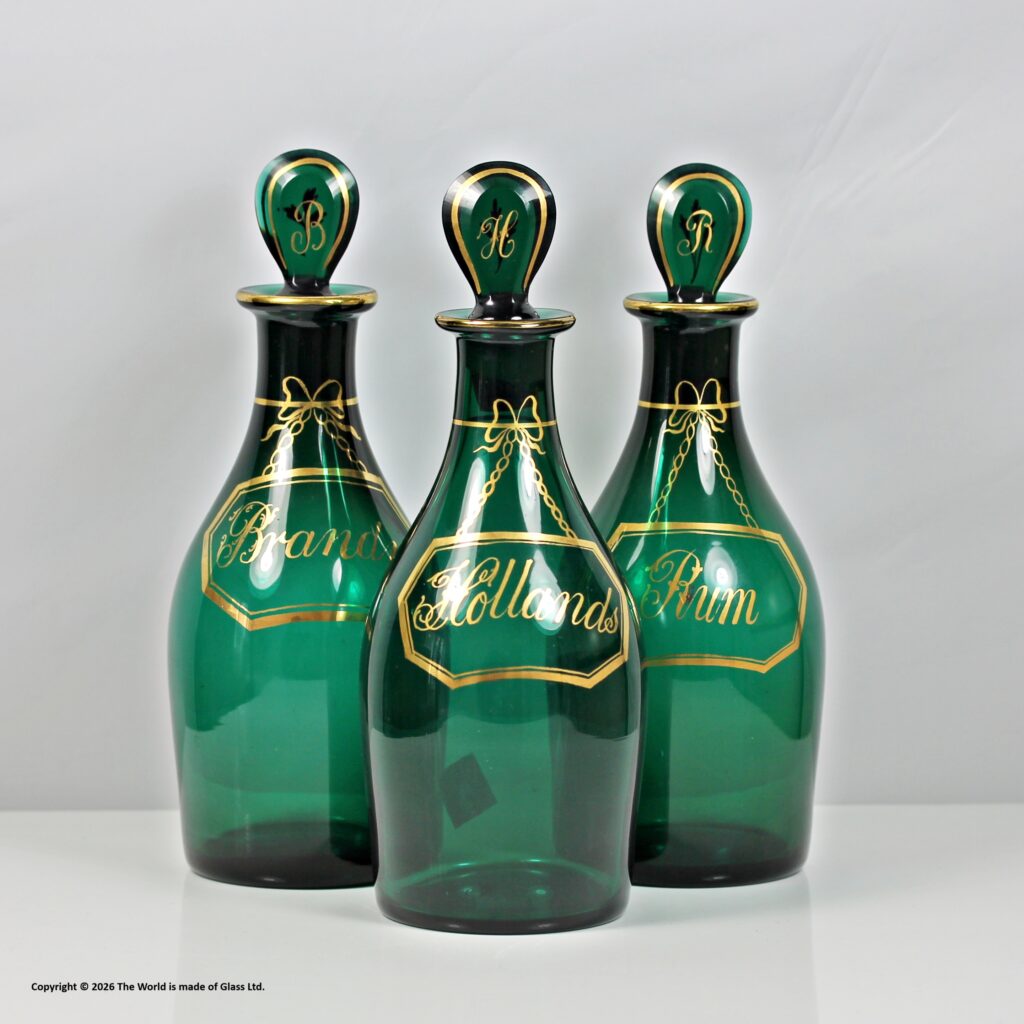 Georgian set of three Bristol green Indian club shaped decanters